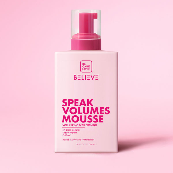 Bottle of 'Believe Speak Volumes Mousse' on a pink background